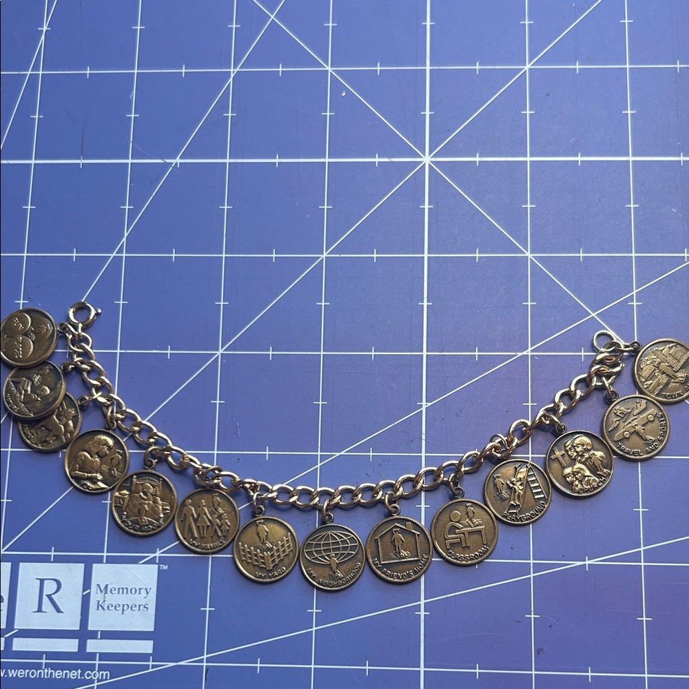Charm bracelet MY charms in penny shaped circles on gold tone spring closure